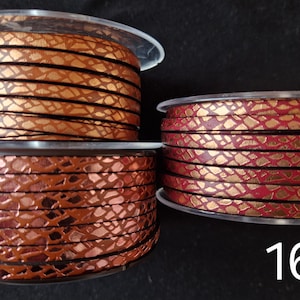 May include: Three spools of flat leather cord labeled 14, 15, and 16. Spool 14 is a metallic copper with a black snakeskin pattern. Spool 15 is a dark bronze with a black snakeskin pattern. Spool 16 is a metallic red with a gold snakeskin pattern.