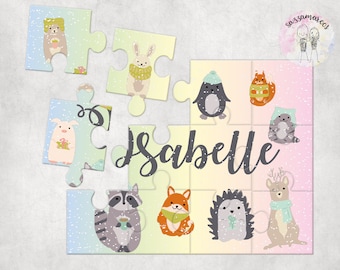 May include: A colorful puzzle featuring a variety of animals, including a penguin, a fox, a hedgehog, and a deer. The puzzle pieces are arranged in a grid pattern and have a snowy background. The name "Isabelle" is written in a cursive font at the top of the puzzle.
