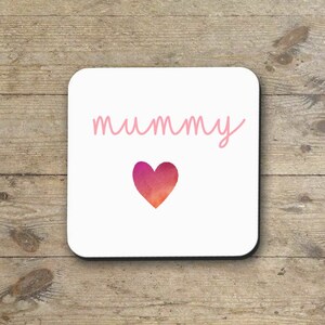 May include: White coaster with the word "mummy" written in pink cursive script and a pink and orange watercolor heart.