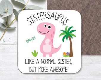 May include: White coaster with a pink dinosaur illustration and the text "Sistersaurus, Rawr! Like a normal sister, but more awesome".