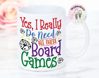 May include: White ceramic mug with a colorful design that says "Yes, I really do need all these board games". The design includes dice and stars.