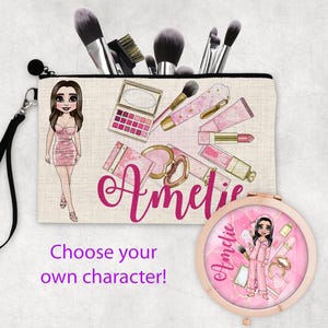 May include: A pink and white makeup bag with a cartoon girl and the name "Amelie" printed on it. The bag is decorated with makeup brushes, lipstick, and other makeup items.