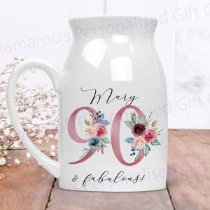 May include: White ceramic mug with a pink floral design and the text "Mary 90 & fabulous!"