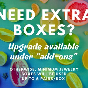 May include: A blue background with a variety of citrus fruits, including oranges, lemons, limes, and grapefruits. The text "NEED EXTRA BOXES? Upgrade available under "add-ons" OTHERWISE, MINIMUM JEWELRY BOXES WILL BE USED UP TO 6 PAIRS/BOX" is written in white.