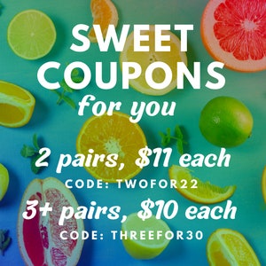 May include: A blue background with various citrus fruits, including limes, lemons, oranges, and grapefruits. The text "SWEET COUPONS for you" is displayed in white letters. Below the text, there are two offers: "2 pairs, $11 each CODE: TWOFOR22" and "3+ pairs, $10 each CODE: THREEFOR30".