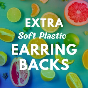 May include: A flat lay image of citrus fruit slices and leaves on a blue and green gradient background. The text "EXTRA Soft Plastic EARRING BACKS" is in white letters on the background.