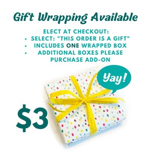 May include: A white gift box with colorful polka dots and a yellow ribbon. The box is tied with a bow and has a speech bubble with the word "Yay!" in it. The text "$3" is in green below the box. The text above the box reads "Gift Wrapping Available" and includes instructions for selecting gift wrapping at checkout.