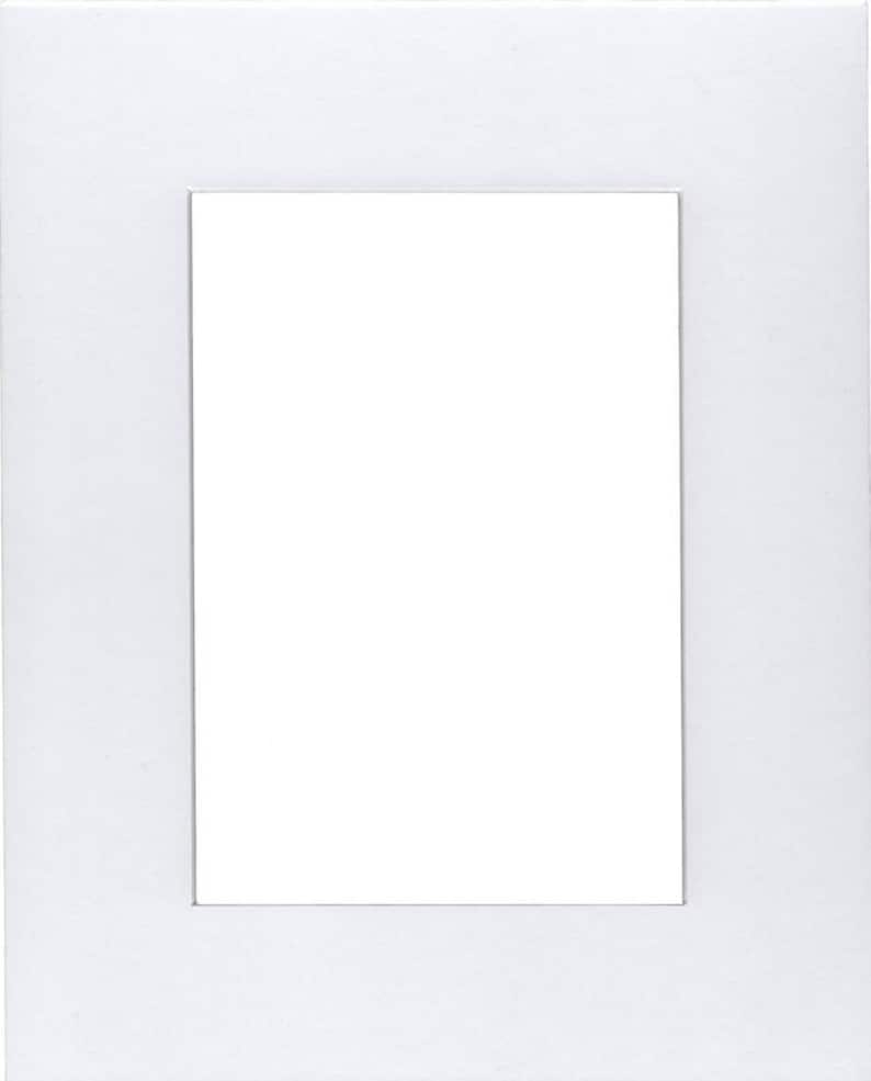 May include: A white mat with a rectangular opening in the center. The mat is designed to hold a photo or artwork.