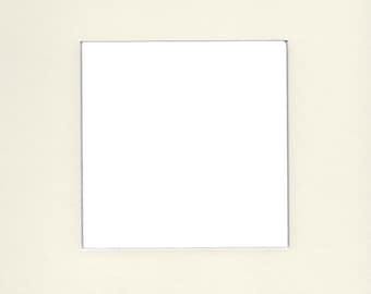 May include: A white mat with a rectangular opening in the center. The mat is off-white and has a subtle texture.