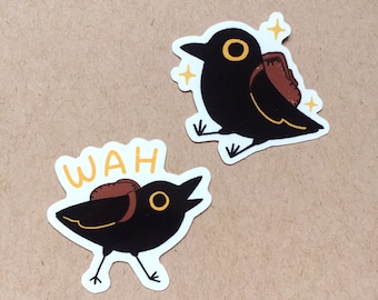 May include: Two black bird stickers with yellow eyes and beaks. One bird is carrying a brown backpack and the other has the word "WAH" above it.