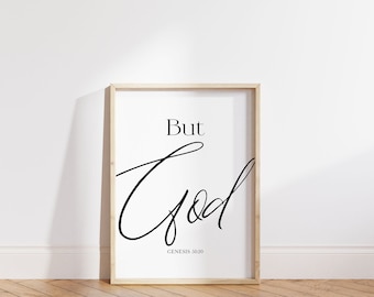 May include: A framed print with a white background and black text that reads "But God" in a cursive font. The text "Genesis 50:20" is printed below the cursive text.
