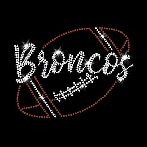 May include: A black graphic featuring the word "Broncos" in white, sparkling rhinestones. The word is superimposed on a football shape outlined in brown rhinestones, with white stripes. The design is suitable for apparel.