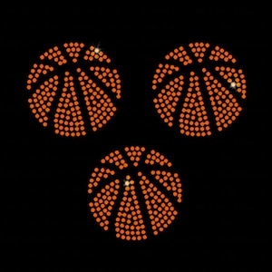 May include: Three orange basketballs, each meticulously crafted with small, round, orange dots, are set against a stark black background. The design captures the essence of a basketball, with the dots forming the iconic panels and lines.