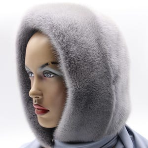 Sapphire mink fur hooded scarf worn by woman - luxurious winter headwear with soft draping, handmade hooded wrap for cold weather
