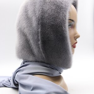 Side profile sapphire fur hood worn - natural movement of handmade mink wrap, hooded scarf framing face with warmth and style