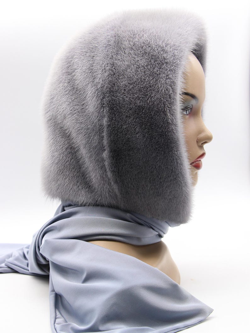 Side profile sapphire fur hood worn - natural movement of handmade mink wrap, hooded scarf framing face with warmth and style