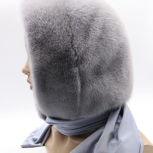 Close-up sapphire mink fur texture - dense natural fur fibers, hooded scarf detail revealing craftsmanship and warmth quality