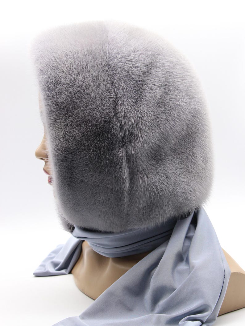 Close-up sapphire mink fur texture - dense natural fur fibers, hooded scarf detail revealing craftsmanship and warmth quality