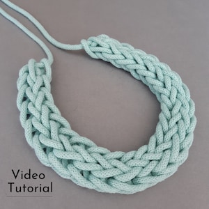May include: A light green braided rope necklace. The necklace is made of a thick, soft rope and has a simple, elegant design.  Video Tutorial.