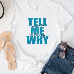 May include: White t-shirt with the text "TELL ME WHY I WANT IT THAT WAY" in blue glitter lettering. The shirt is paired with denim shorts, sunglasses, and sandals.