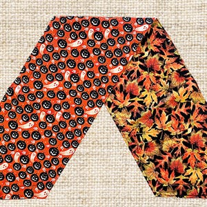 May include: A reversible table runner with a Halloween theme. One side features a black and orange pattern of jack-o'-lanterns and ghosts on an orange background. The other side features a black and orange pattern of autumn leaves on a black background.