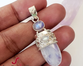 May include: Silver pendant featuring a teardrop-shaped moonstone with a smaller moonstone accent. The pendant has intricate silver detailing around the larger stone.