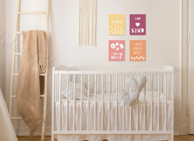 May include: Four framed prints with positive affirmations for children. The prints are in a nursery setting with a white cot and a brown blanket on a ladder.