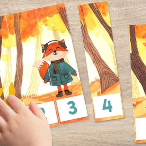 May include: A five-piece puzzle featuring a fox wearing a blue coat and earmuffs in a forest setting. The puzzle pieces are numbered 1 through 5.