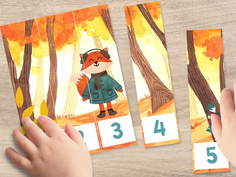 May include: A five-piece puzzle featuring a fox wearing a blue coat and earmuffs in a forest setting. The puzzle pieces are numbered 1 through 5.