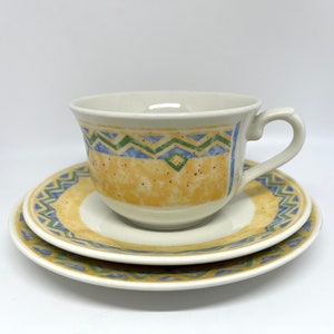 May include: A set of ceramic teacups and saucers with a yellow, blue, and green geometric pattern. The cups and saucers have a speckled glaze.