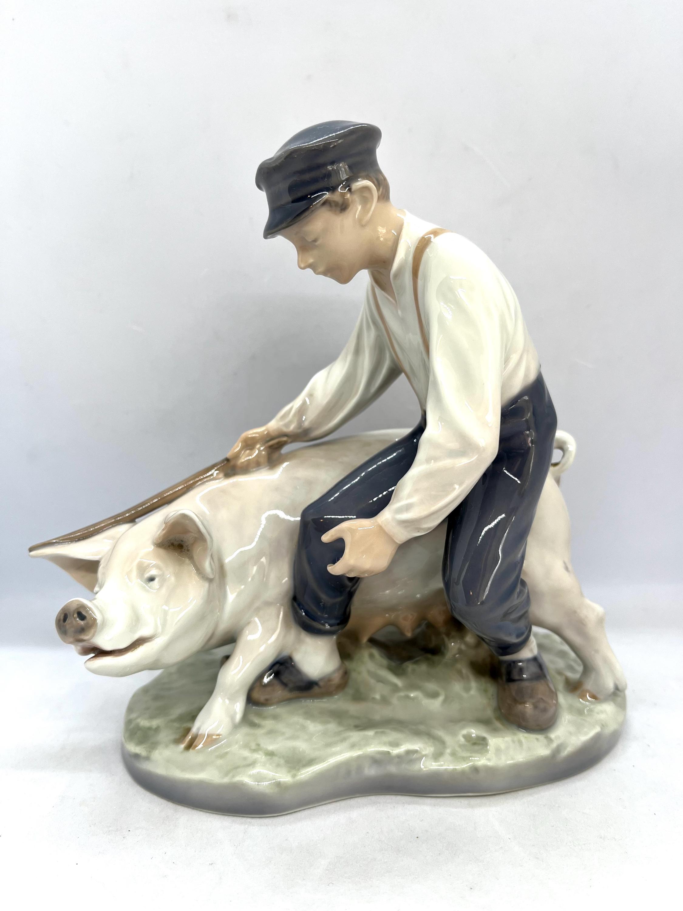 Royal Copenhagen Figurine, Farmer Boy With a Pig, Large Figurine