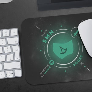 May include: A black mouse pad with a green circle design featuring the text "FFXIV SMN DISCIPLE OF MAGIC BOOKS".