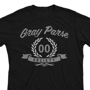 May include: Black t-shirt with a white graphic design that says "Gray Parse 00 Society" with a laurel wreath around the number 00.