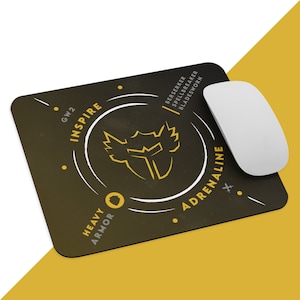 May include: A black and yellow gaming mouse pad with the words "Inspire", "Heavy Armor", and "Adrenaline" printed on it. The mouse pad also features a stylized image of a warrior's helmet.