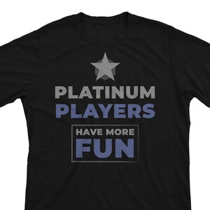 May include: Black t-shirt with a gray star and the text "Platinum Players Have More Fun" in blue.