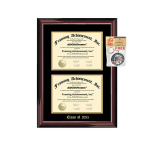 May include: A mahogany-colored frame with a black mat and gold lettering. The frame holds two diplomas with the text "Framing Achievement, Inc." and "AllGiftFrames". The frame also includes a small, free keychain with a red, white, and blue design.