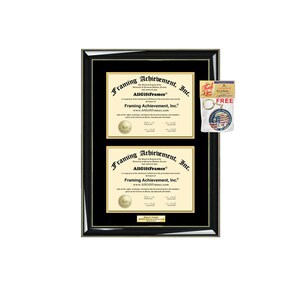 May include: A black double diploma frame with gold accents. The frame holds two certificates with gold seals and the text "Framing Achievement, Inc." A small keychain with a patriotic design is attached to the frame.