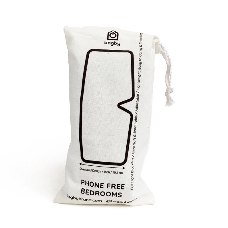 May include: White cotton drawstring bag with black text that reads "bagby" and "PHONE FREE BEDROOMS". The bag is designed to hold a sleep mask and has a black outline of a sleep mask on the front. The text also reads "Full Light Blockout / Ultra Soft & Breathable / Adjustable / Lightweight, Easy to Carry & Travelling" and "Oversized Design 4 inch / 10.2 cm".