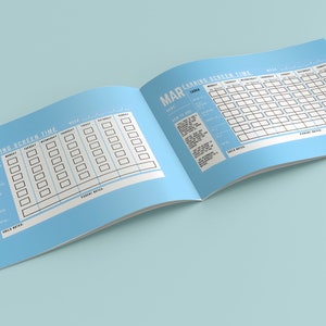 May include: Open notebook with a light blue cover, featuring a screen time tracker for March. The pages display a weekly grid for tracking screen time, with sections for notes. Text includes "Spending Screen Time" and "Learning Screen Time".