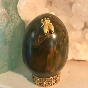 Stone egg with golden beetle