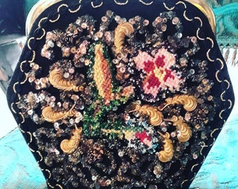 May include: A black velvet purse with a gold metal frame and a floral design made of sequins and beads.