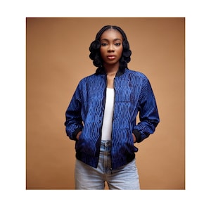 May include: A blue and black patterned bomber jacket with a zipper closure. The jacket has a ribbed collar and cuffs.