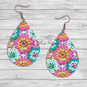 May include: A pair of teardrop-shaped earrings with a crocheted design in shades of pink, green, blue, and white. The earrings have a silver hook.