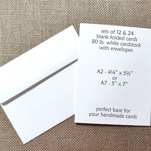 May include: A white envelope and a white folded card with black text that reads: sets of 12 & 24 blank folded cards 80 lb. white cardstock with envelopes A2 - 4 1/4" x 5 1/2" or A7 - 5" x 7" perfect base for your handmade cards.