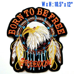 May include: An embroidered patch with a white bald eagle inside a dreamcatcher with feathers. The patch is black with orange text that reads "Born to Be Free" and "Freedom". The patch measures 10.5 inches by 12 inches.