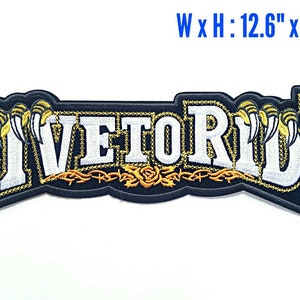 May include: Black embroidered patch with white lettering that reads "Live to Ride". The lettering is outlined in gold and has a gold barbed wire design with a rose underneath. The patch measures 12.6 inches wide by 4.2 inches high.
