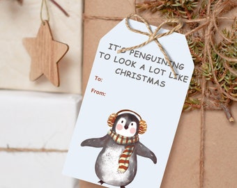 May include: Gift-wrapped presents with decorative accents. One gift has a wooden star and red berries, another has a tag that says "It's penguining to look a lot like Christmas" with a penguin illustration. The gifts are tied with twine.