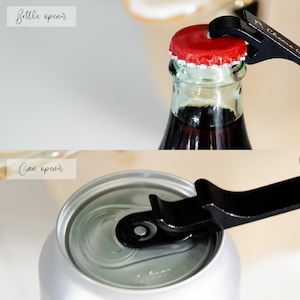 May include: A black multi-tool with a bottle opener and a can opener. The bottle opener is being used to open a bottle of soda with a red cap. The can opener is being used to open a silver can.