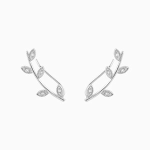 May include: Silver earrings with a delicate leaf design and clear cubic zirconia stones.