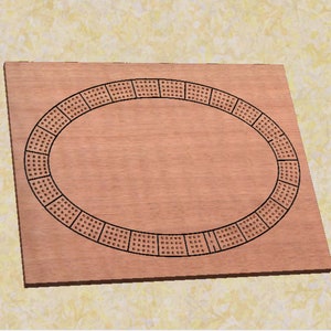 May include: A wooden cribbage board with a circular playing area and a black border. The board has a natural wood finish.